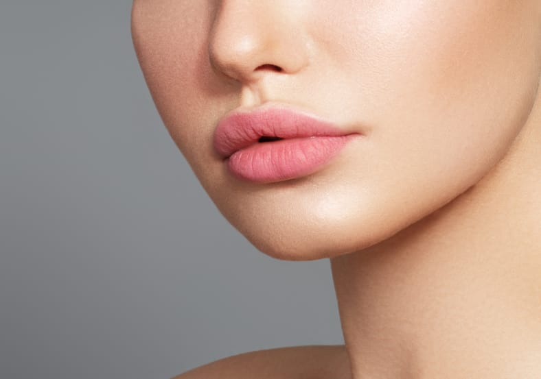Close up of a woman's full, plump lips after lip filler injections